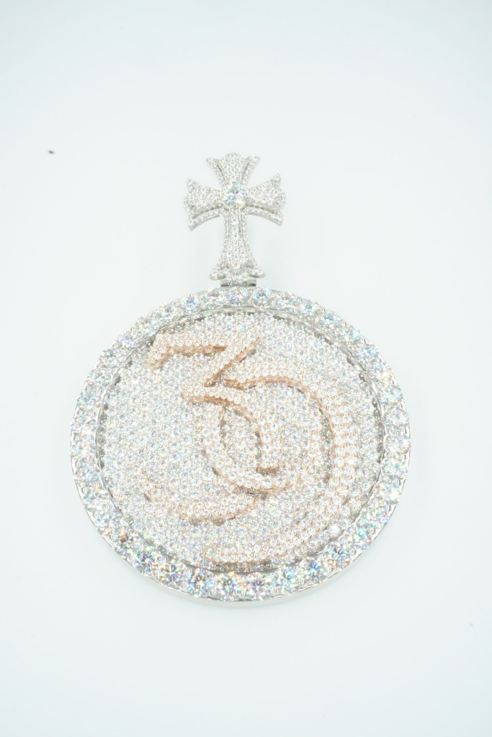 Pavé diamond medallion pendant with a gothic cross bail