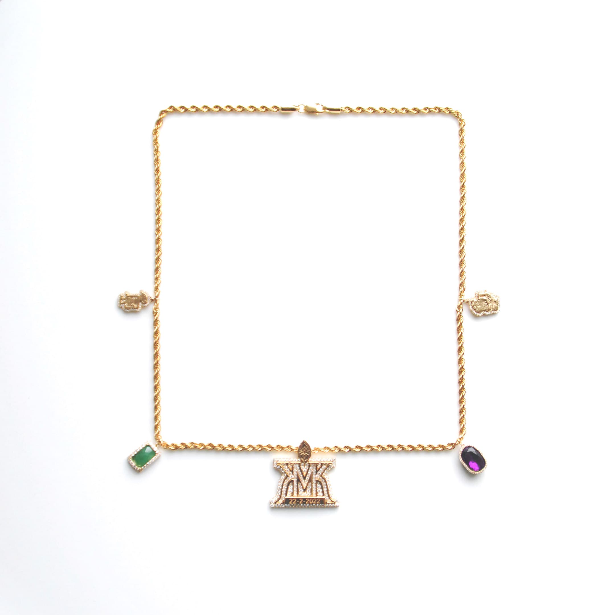 Gold rope necklace stationed with a monogram and gemstone charms