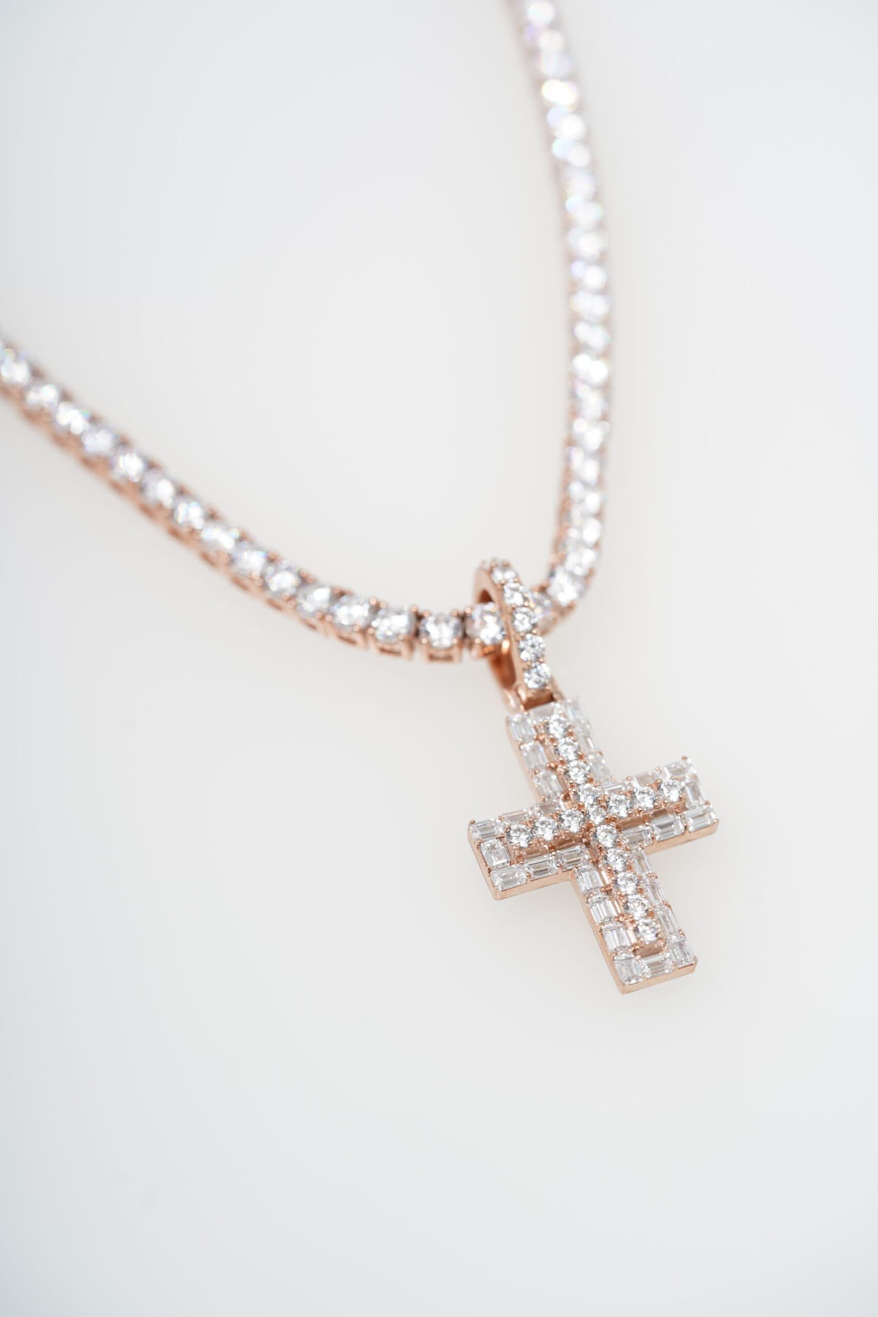 Baguette diamond cross on a rose gold tennis chain